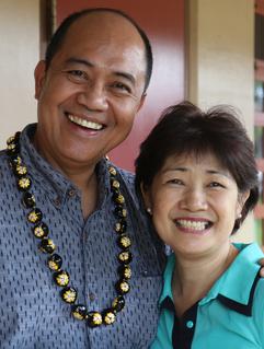 A man and woman smile for the camera.