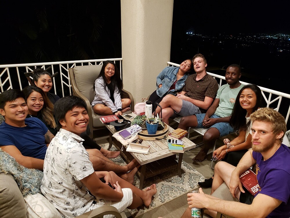 A group of people sitting on top of a patio.